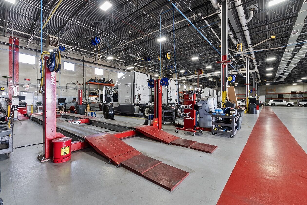 Heavy-duty lifts and a semi truck in the Motion Truck Center shop